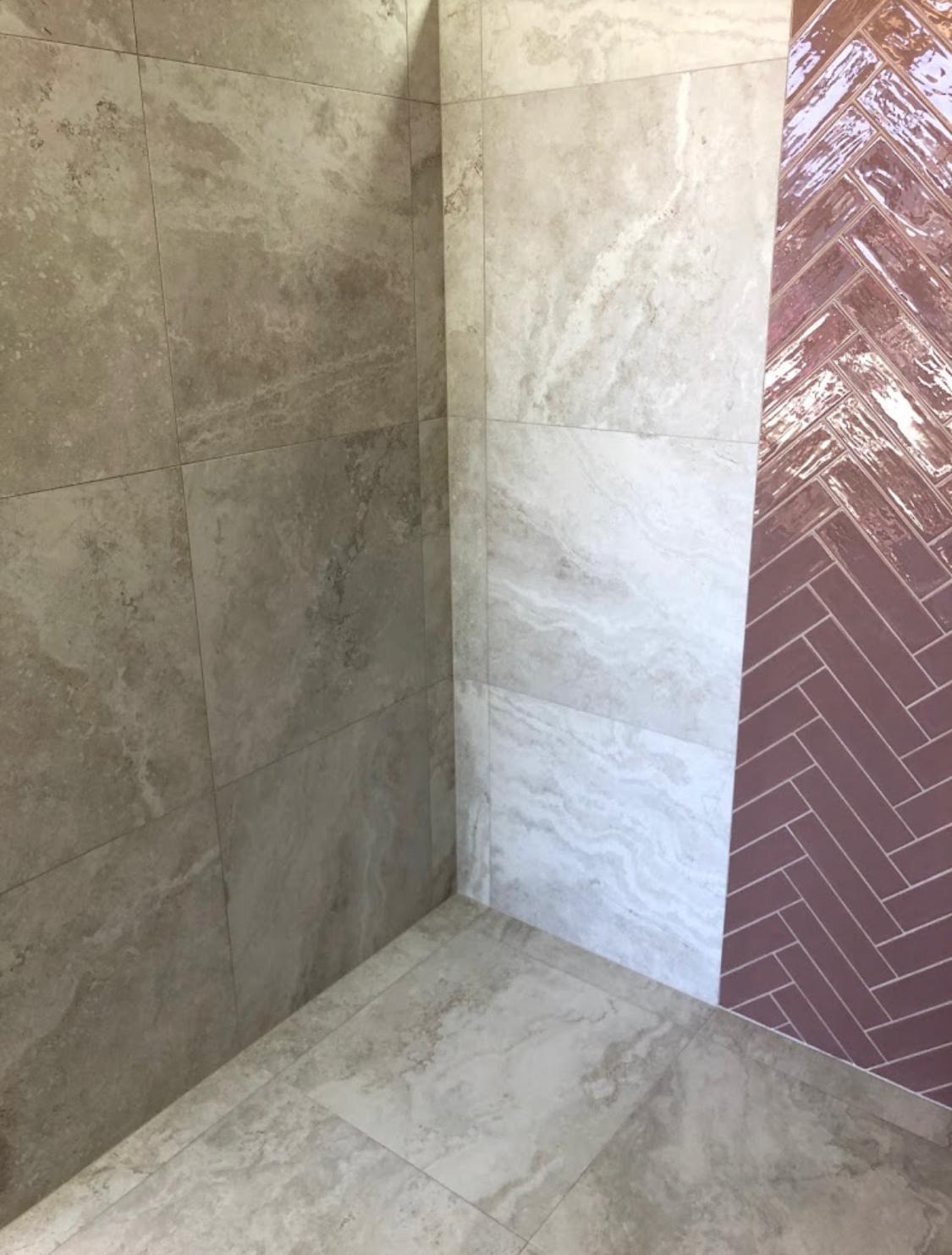 Travertine bathroom with burgundy herringbone feature wall — Perth Tiling WA project